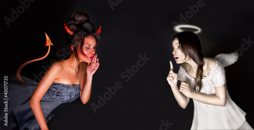 Photo: Portrait of angel and devil girls and copyspace between them. Portrait of angel and devil girls and copyspace between them.