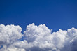 white fluffy clouds over blue sky landscape