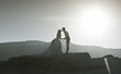 Photo: Silhouette image of a bride and groom by the beach at sunset Silhouette image of a bride and groom by the beach at sunset