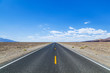 Death Valley road straight across the desert to the mountains in