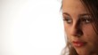 Half face of sad beautiful young woman isolated
