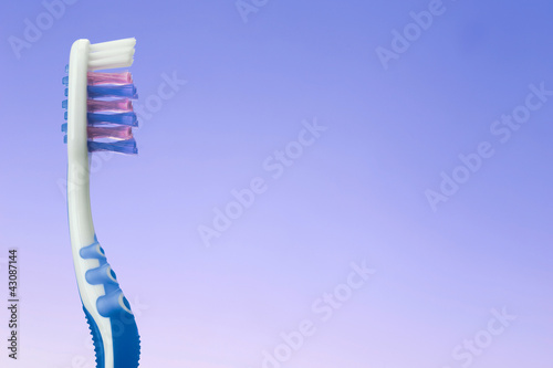 Photo: toothbrush on blue background toothbrush on blue background