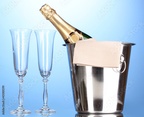 Photo: Champagne bottle in bucket with ice and glasses Champagne bottle in bucket with ice and glasses