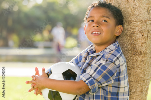 Foto: Mixed Race Boy Holding Soccer Ball in the Park Mixed Race Boy Holding Soccer Ball in the Park