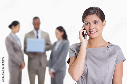 Photo: Woman with her head tilted slightly smiling on the phone and co- Woman with her head tilted slightly smiling on the phone and co-