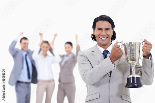 Photo: Close-up of a man dressed in a suit smiling and holding a cup wi Close-up of a man dressed in a suit smiling and holding a cup wi