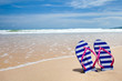 Colorful flipflop pair on sea beach