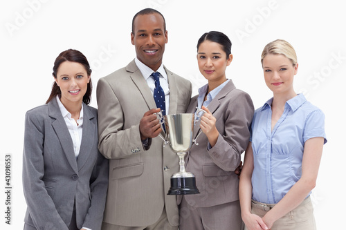 Photo: Close-up of a business team holding a cup Close-up of a business team holding a cup