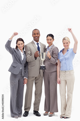 Photo: Happy business team holding a cup Happy business team holding a cup