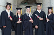 Smiling graduates posing