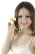 Photo: Sexy young woman holding white frangipani Sexy young woman holding white frangipani