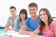A group of smiling people turned and looking at the camera
