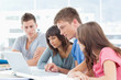 Photo: A group all looking into the laptop A group all looking into the laptop
