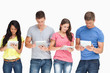 A group standing beside each other and using their tablet pc's