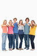 A group smiling and giving the thumbs up