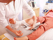 Doctor bandaging patient in hospital.