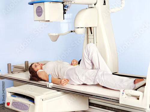 Photo: Patient in x-ray room looking at doctor. Patient in x-ray room looking at doctor.