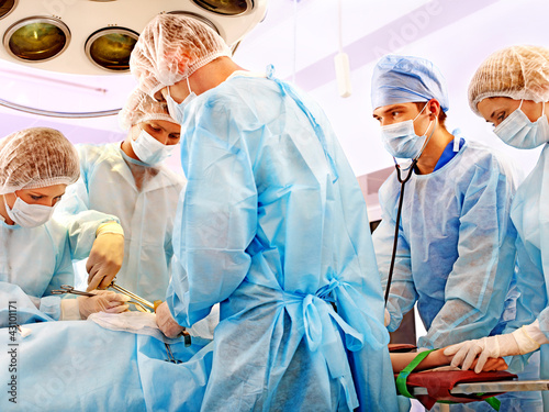 Photo: Surgeon at work in operating room. Surgeon at work in operating room.