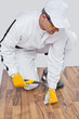 Worker nailed a nail with a hammer on the wooden floor