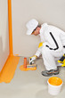 worker waterproofing around the wall, floor and siphon