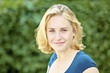 Photo: Pretty, young woman against green background Pretty, young woman against green background