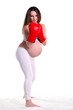 Photo: Young pregnant woman wearing a pair of boxing gloves Young pregnant woman wearing a pair of boxing gloves