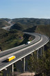 Aerial view of motorway with yellow and white trucks