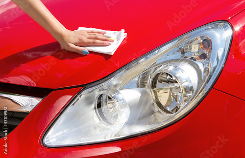 Photo: Young girl polishing car Young girl polishing car