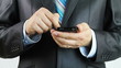 Businessman sending digital message from smart phone