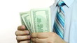 Businessman counts money in hands.