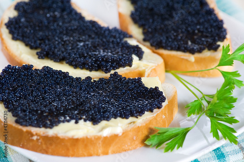 Photo: Black caviar on a slice of bread and butter Black caviar on a slice of bread and butter