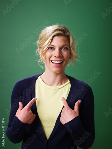 Photo: woman pointing at herself, studio shot woman pointing at herself, studio shot