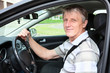 Photo: Happy mature driver with car key sitting in own car Happy mature driver with car key sitting in own car