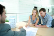 Couple in real-estate agency signing contract