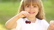 Girl playing with cherries.