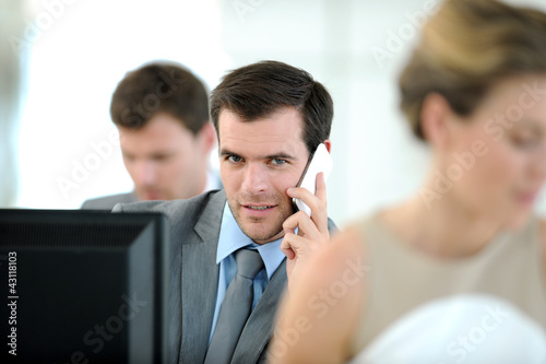 Photo: Office worker sitting in front of desktop Office worker sitting in front of desktop