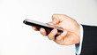 Businessman sending digital message from smart phone