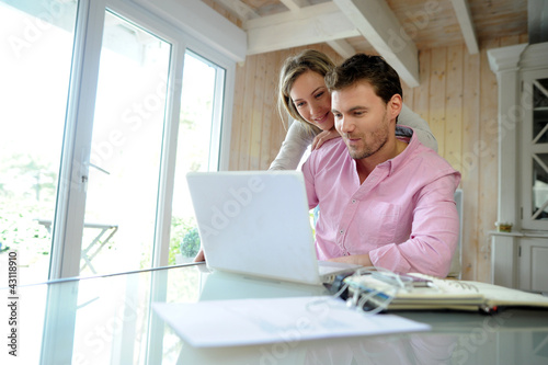 Photo: Couple at home using laptop computer Couple at home using laptop computer
