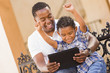 Mixed Race Father and Son Using Touch Pad Computer Tablet