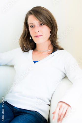 Photo: woman on the couch in the living room woman on the couch in the living room