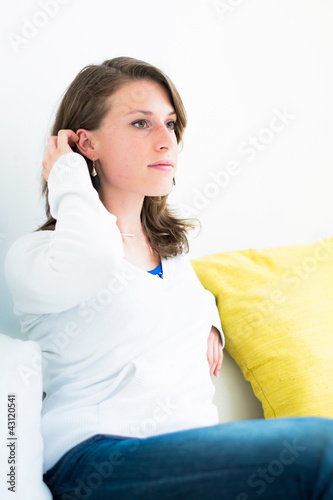 Photo: woman on the couch in the living room woman on the couch in the living room