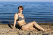 The woman sunbathes on a beach