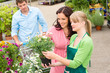 Photo: Garden center florist selling flowers to couple Garden center florist selling flowers to couple
