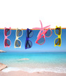 Foto: Collection of sunglasses on the beach Collection of sunglasses on the beach