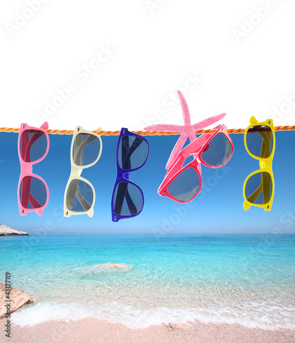 Photo: Collection of sunglasses on the beach Collection of sunglasses on the beach