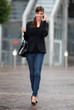 Photo: Femme d'affaire arrivant au bureau et parlant au telephone porta Femme d'affaire arrivant au bureau et parlant au telephone porta