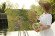 Woman painting outdoors