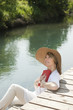 Woman reading by the river