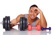 Portrait of muscle man posing in studio with dumbbells