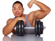 Portrait of muscle man posing in studio with dumbbells